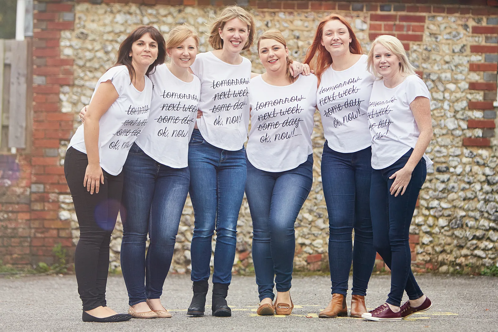 Members of the South Lane Dental team in matching printed t-shirts outside the practice